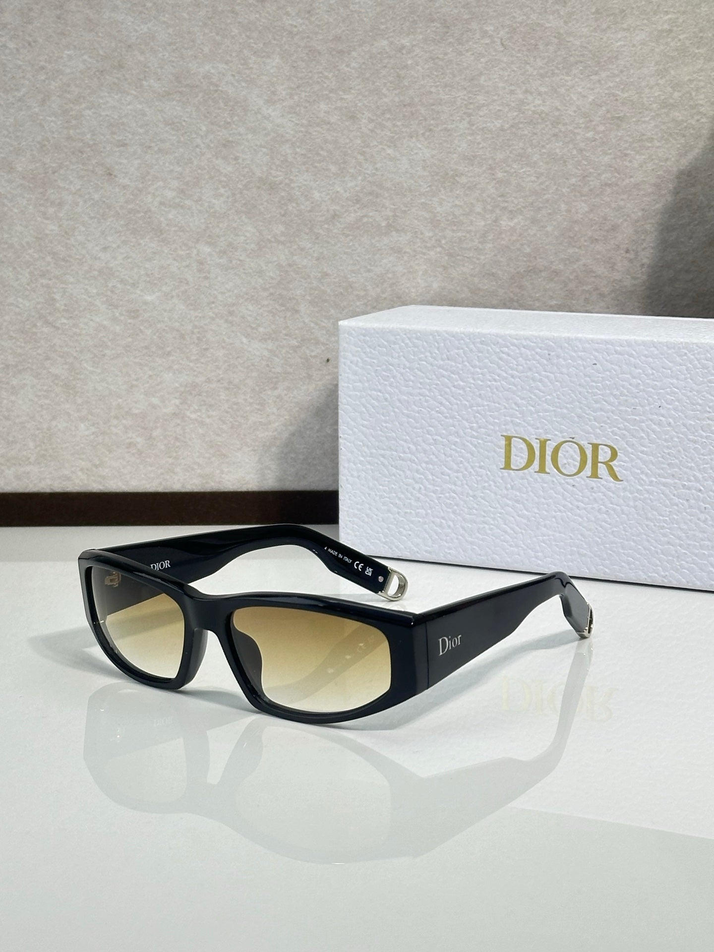 Dior sunglasses with black frame and amber-tinted lenses