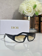 Dior sunglasses with black frame and light gold-tinted lenses