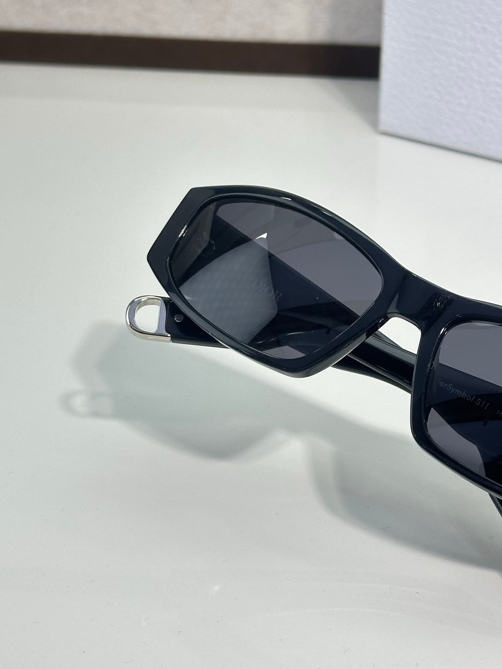 Dior sunglasses close-up with dark lenses and black frame