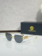 Versace eyeglasses with dark tinted lenses and gold-tone metal frame, rectangular shape