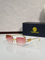 Versace eyeglasses with pink tinted lenses and gold-tone metal frame, rectangular shape