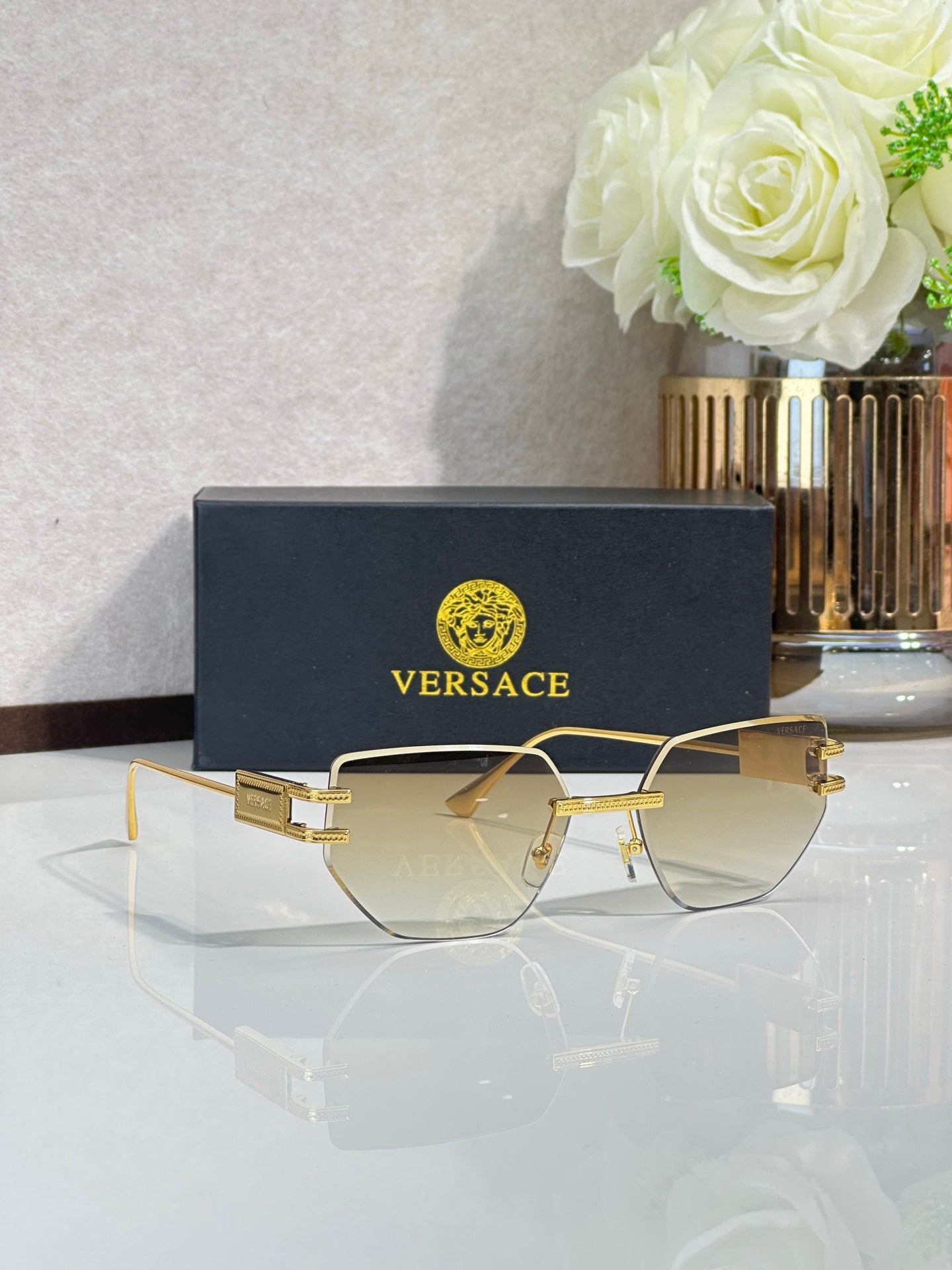 Versace eyeglasses with cream tinted lenses and gold-tone metal frame, rectangular shape