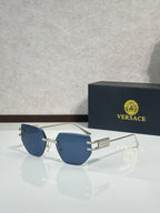 Versace eyeglasses with blue tinted lenses and gold-tone metal frame, rectangular shape