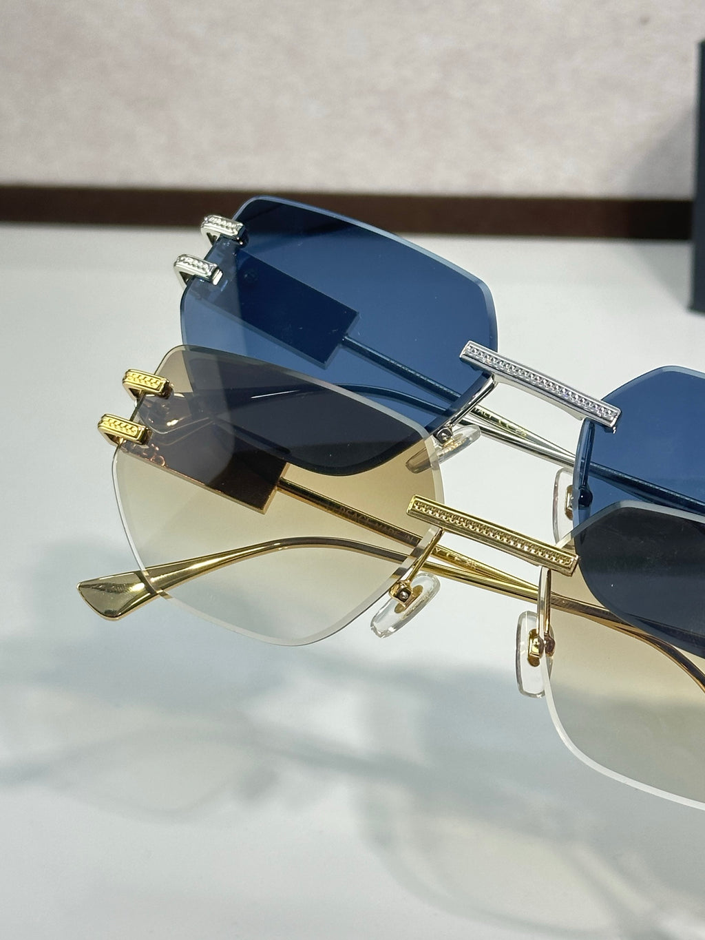 Versace sunglasses with dark blue lenses and gold-tone metal frame, oversized rectangle