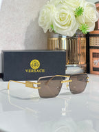 Versace sunglasses with gold frame and smoky gray tinted lenses