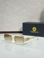 Versace sunglasses with gold metal frame and light gold tinted lenses