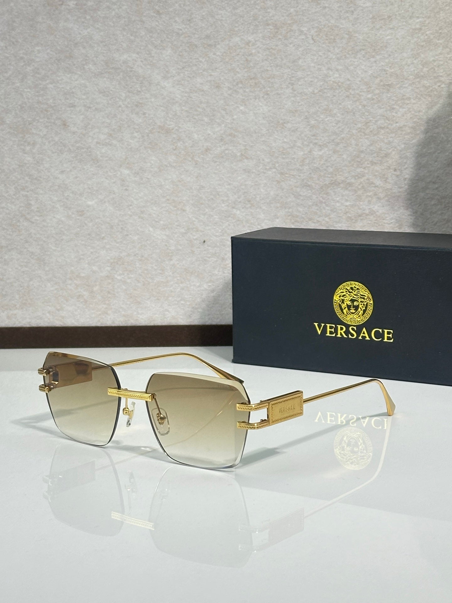 Versace sunglasses with gold metal frame and light gold tinted lenses