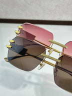 Versace sunglasses close-up, gold frame with pink and dark brown lenses