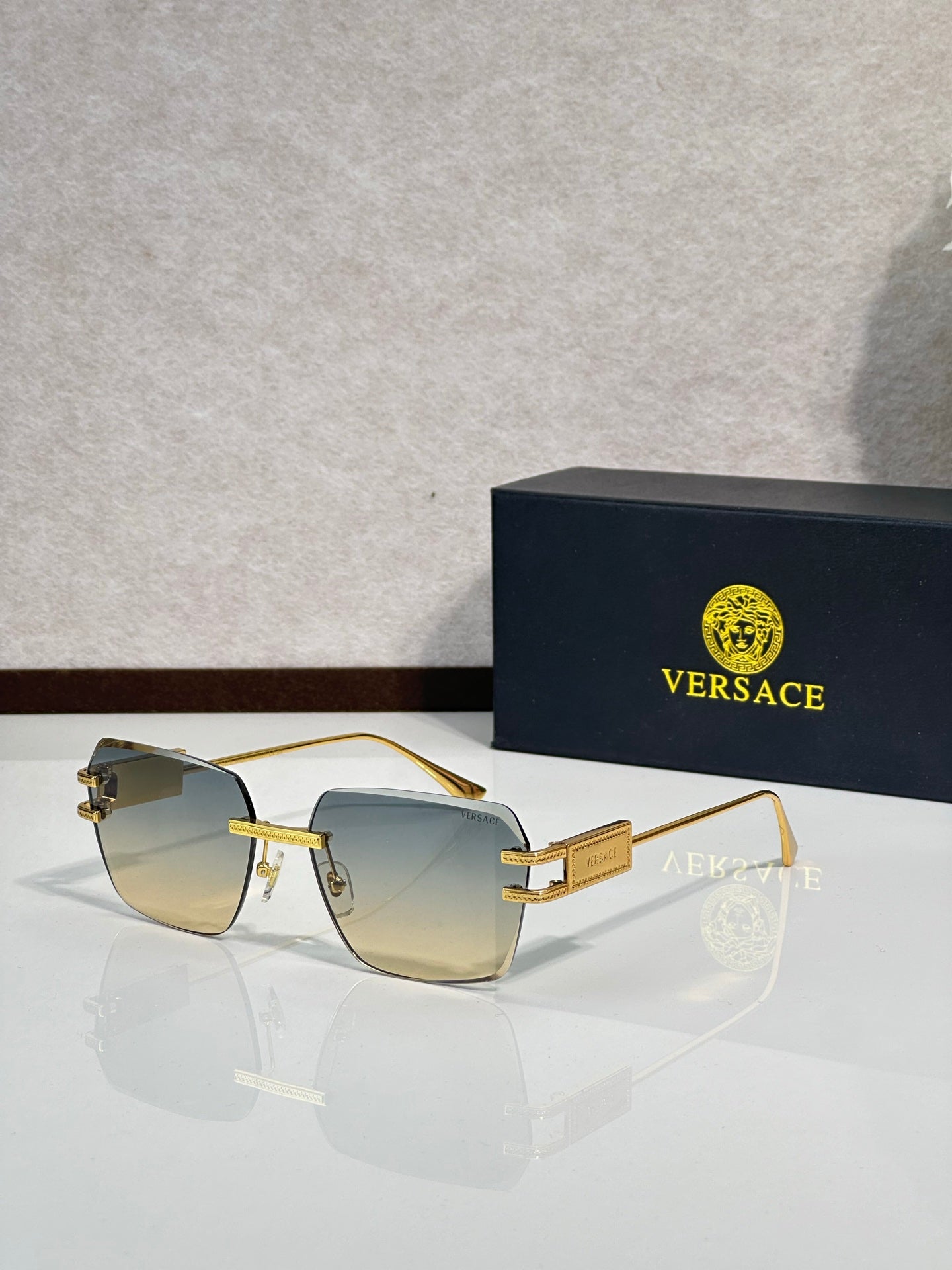 Versace sunglasses with gold frame and pale gold tinted lenses