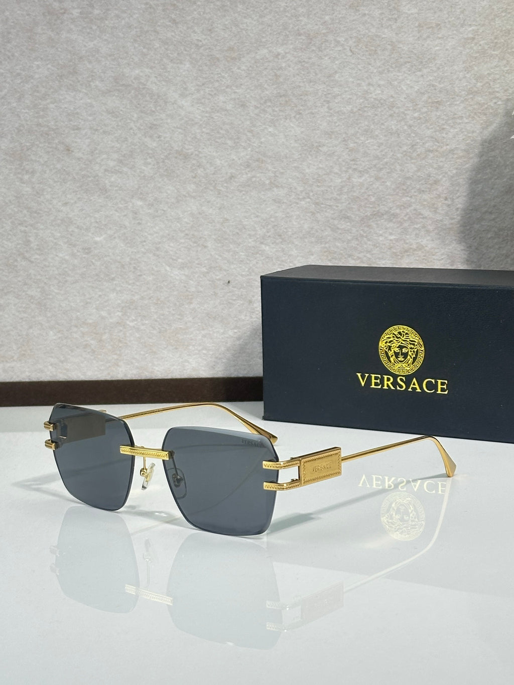 Versace sunglasses, gold frame with blue gradient tinted lenses