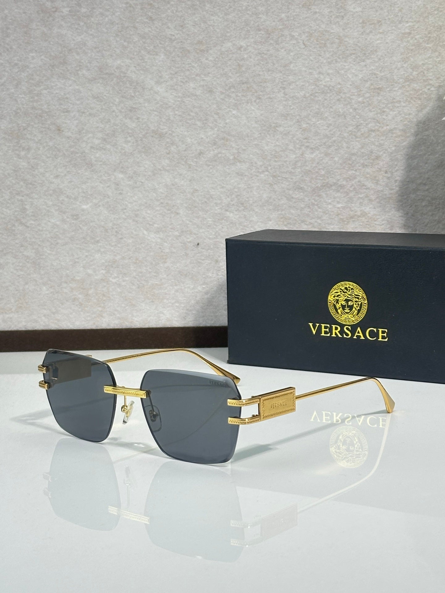 Versace sunglasses, gold frame with blue gradient tinted lenses