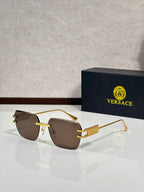 Versace sunglasses with gold metal frame and brown tinted lenses