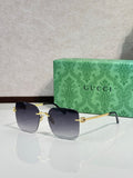 Gucci sunglasses with dark blue gradient lenses and gold-tone frame, round shape