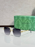 Gucci sunglasses with dark blue gradient lenses and gold-tone frame, round shape