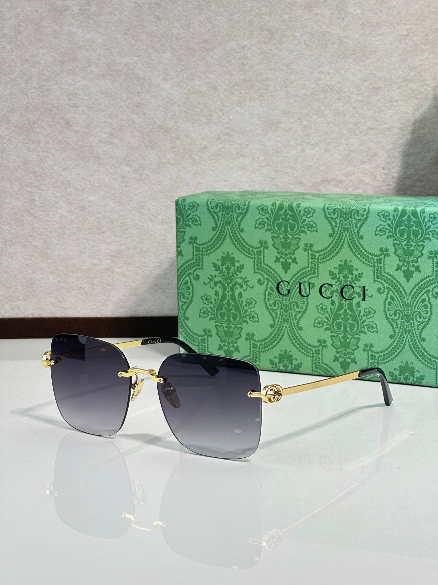 Gucci sunglasses with dark blue gradient lenses and gold-tone frame, round shape