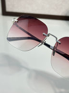 Gucci sunglasses close-up with burgundy tinted lens and metal bridge hardware