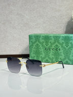 Gucci sunglasses with dark blue gradient lenses and gold-tone frame, front view