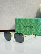 Gucci sunglasses with dark blue gradient lenses and gold-tone frame, side view