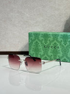Gucci sunglasses with burgundy gradient lenses and gold-tone frame, front view