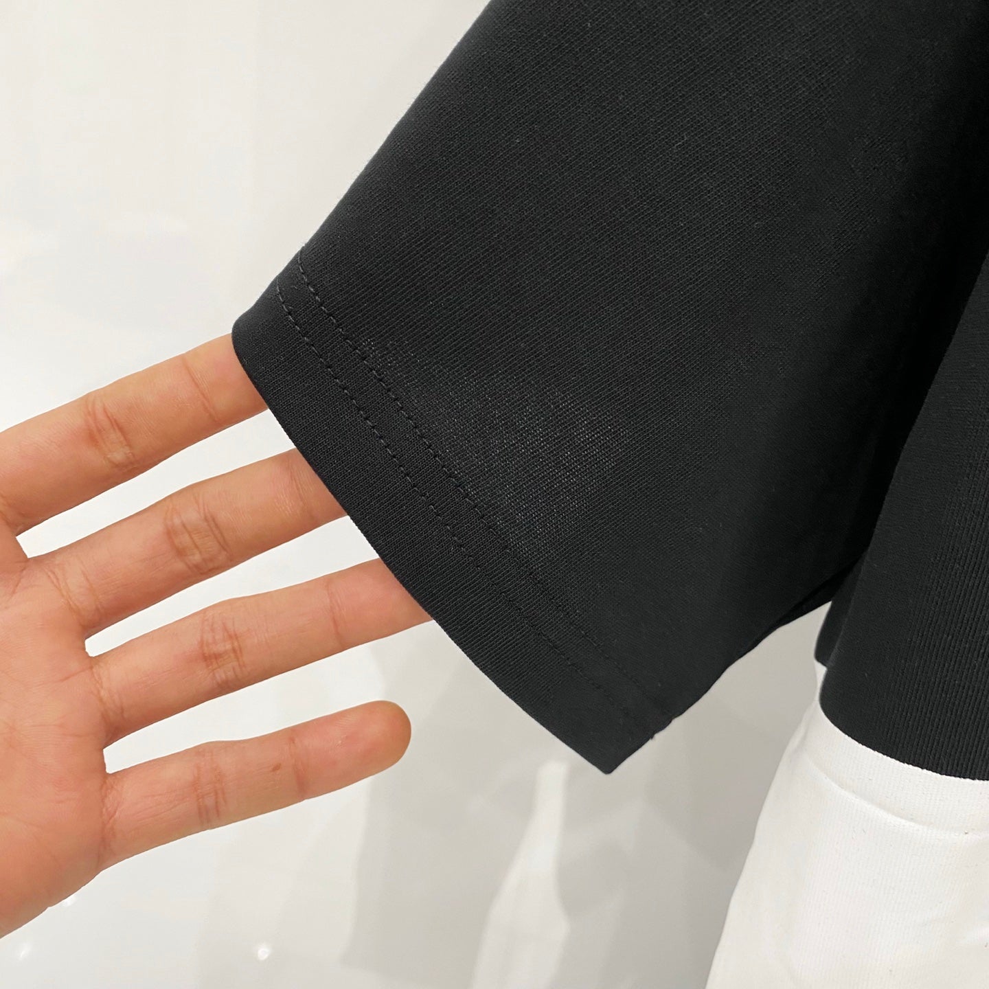 Black short-sleeve cuff with stitched hem detail