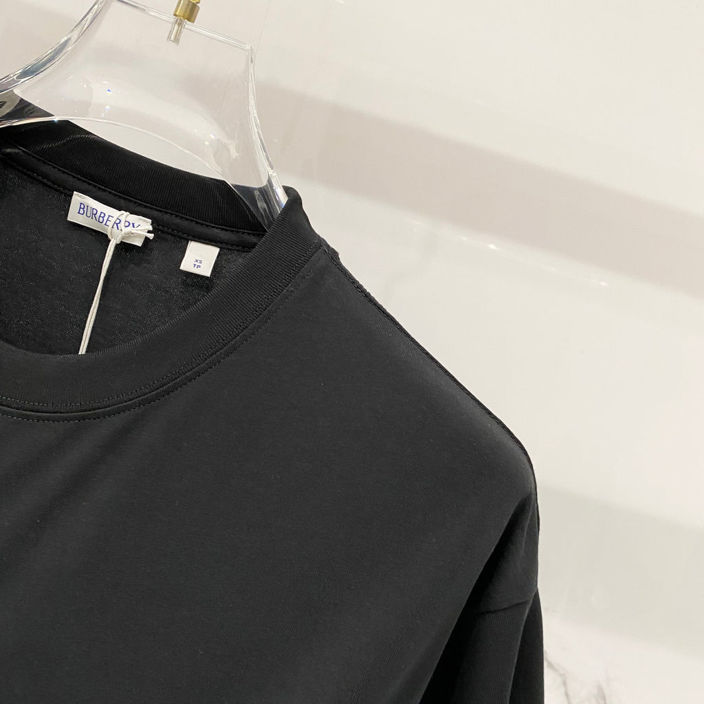 Black T-shirt front with crew neckline and hanging inner label