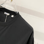 Black T-shirt front with crew neckline and hanging inner label