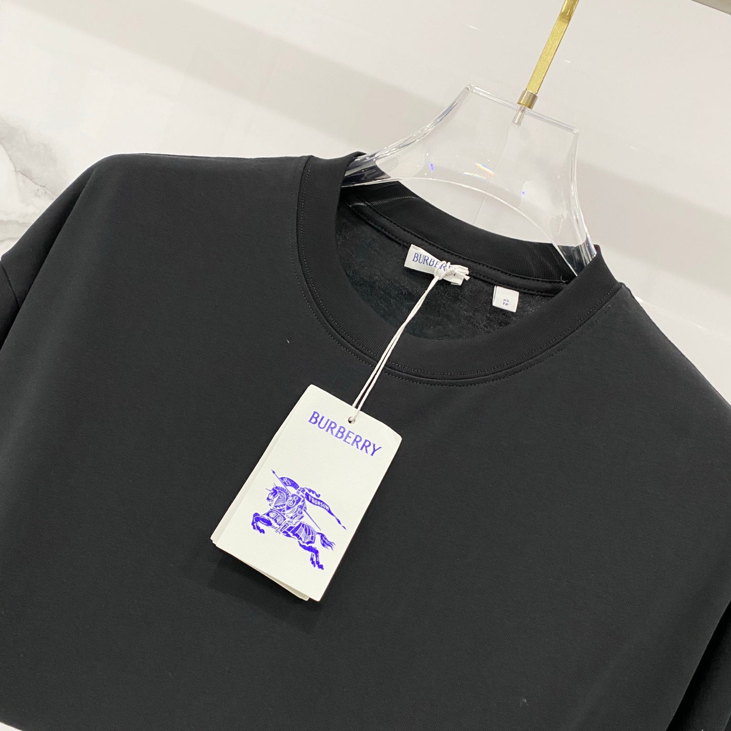 Black crew-neck T-shirt with Burberry neck label and hanging tag