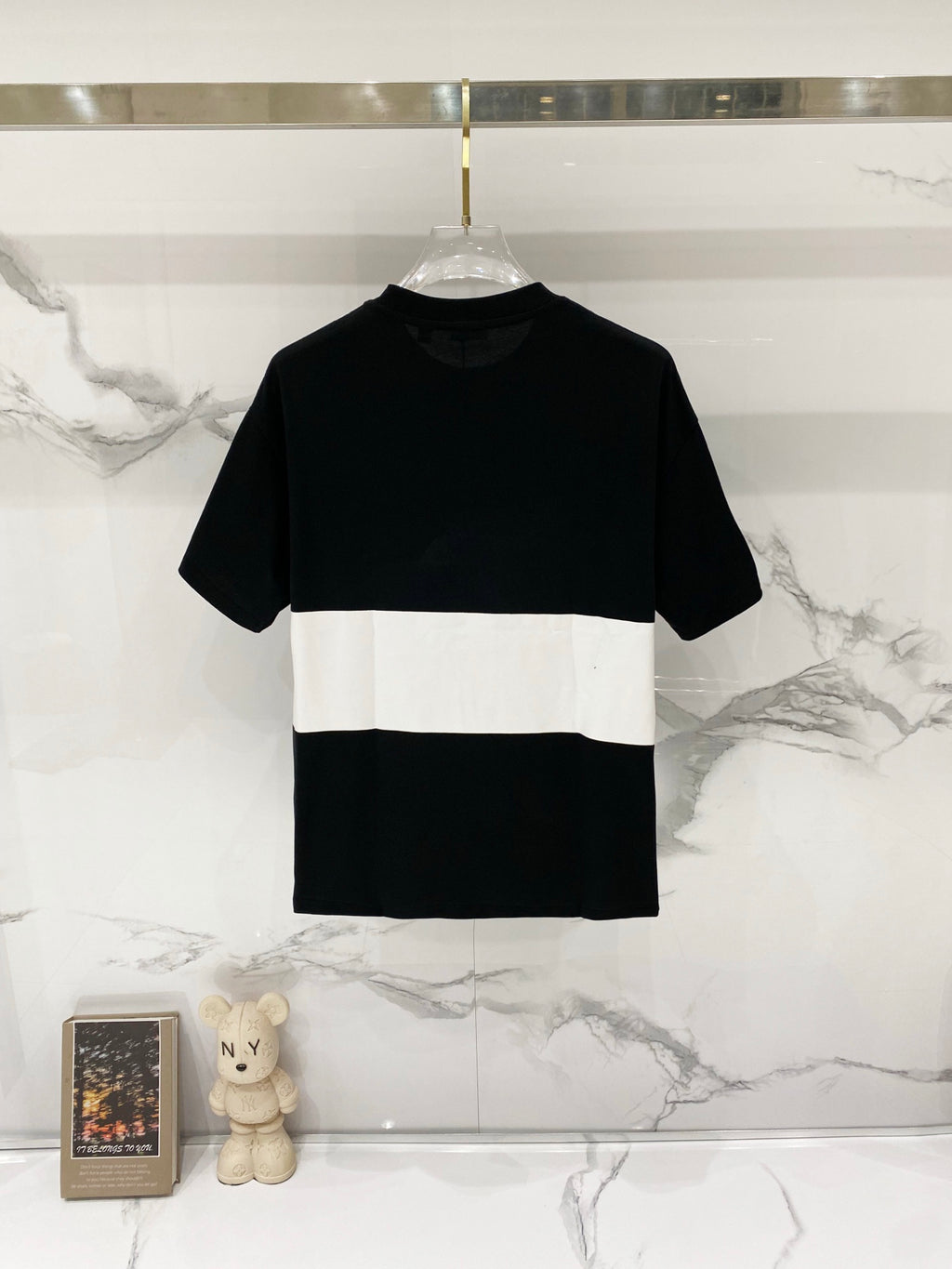 Black and white colorblock T-shirt on hanger, crew neck and short sleeves