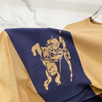 Tan T-shirt with navy panel and gold horse rider graphic