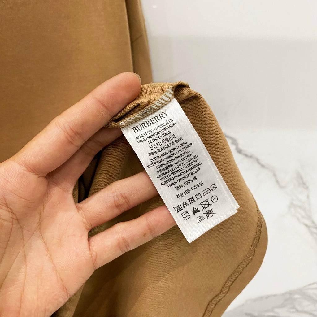Tan Burberry T-shirt care label detail on inside neck seam