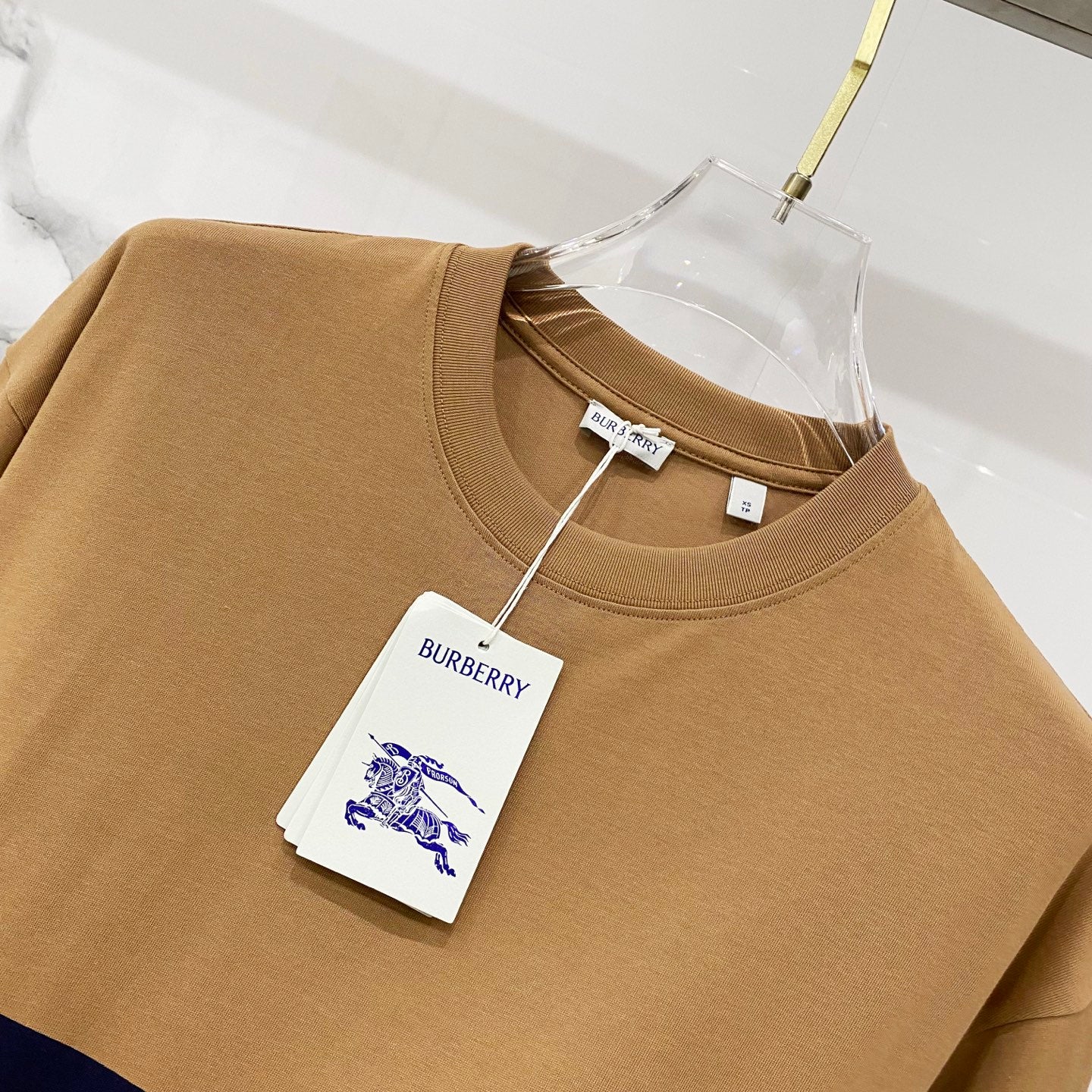 Tan Burberry crewneck T-shirt with hanging labels and neck tag