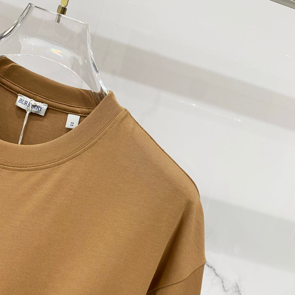 Tan short-sleeve crewneck T-shirt, side view with label tags