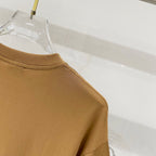 Tan crewneck T-shirt with ribbed neckline, side profile on hanger
