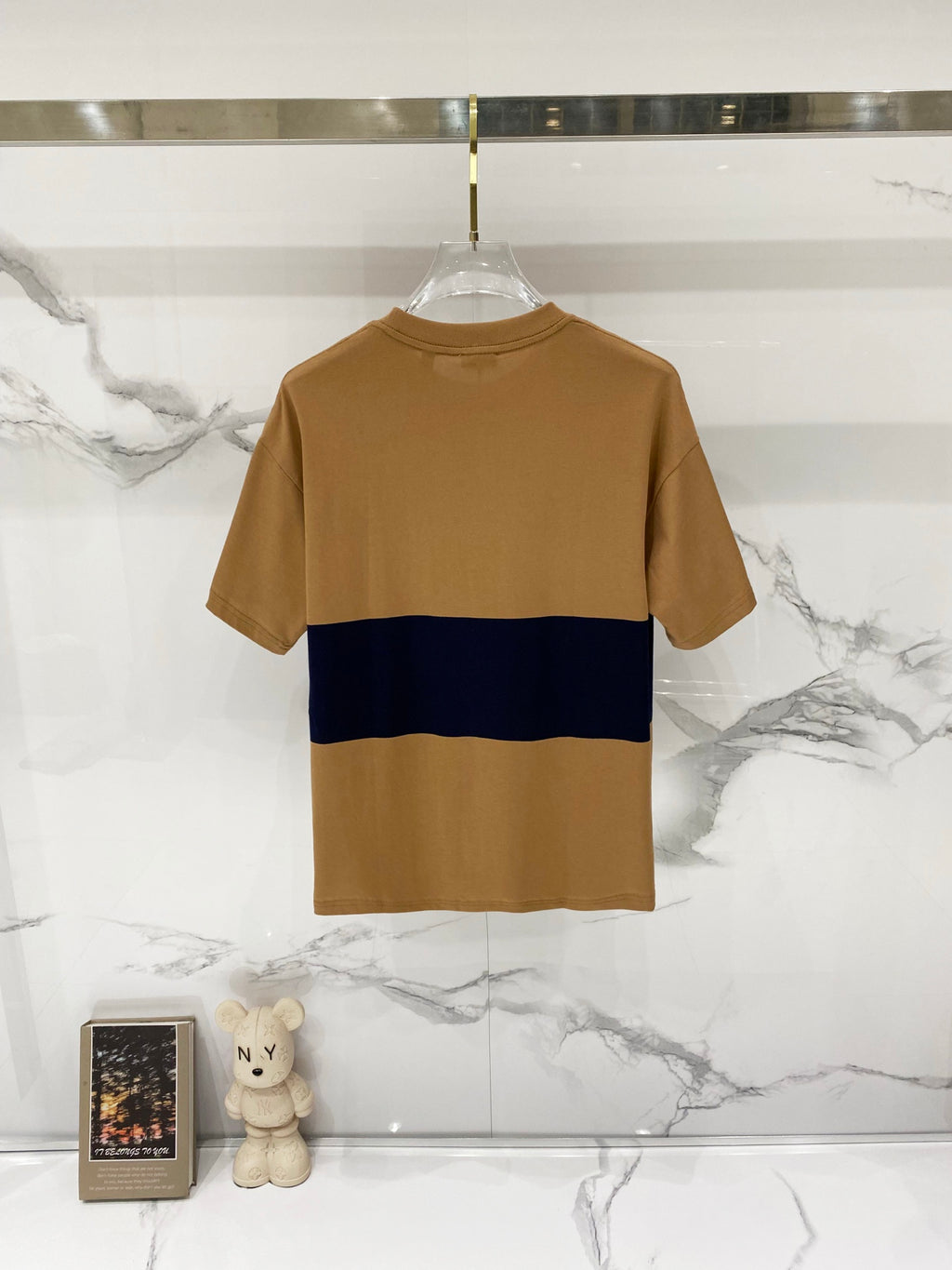 Tan crewneck short-sleeve T-shirt with navy stripe across the chest