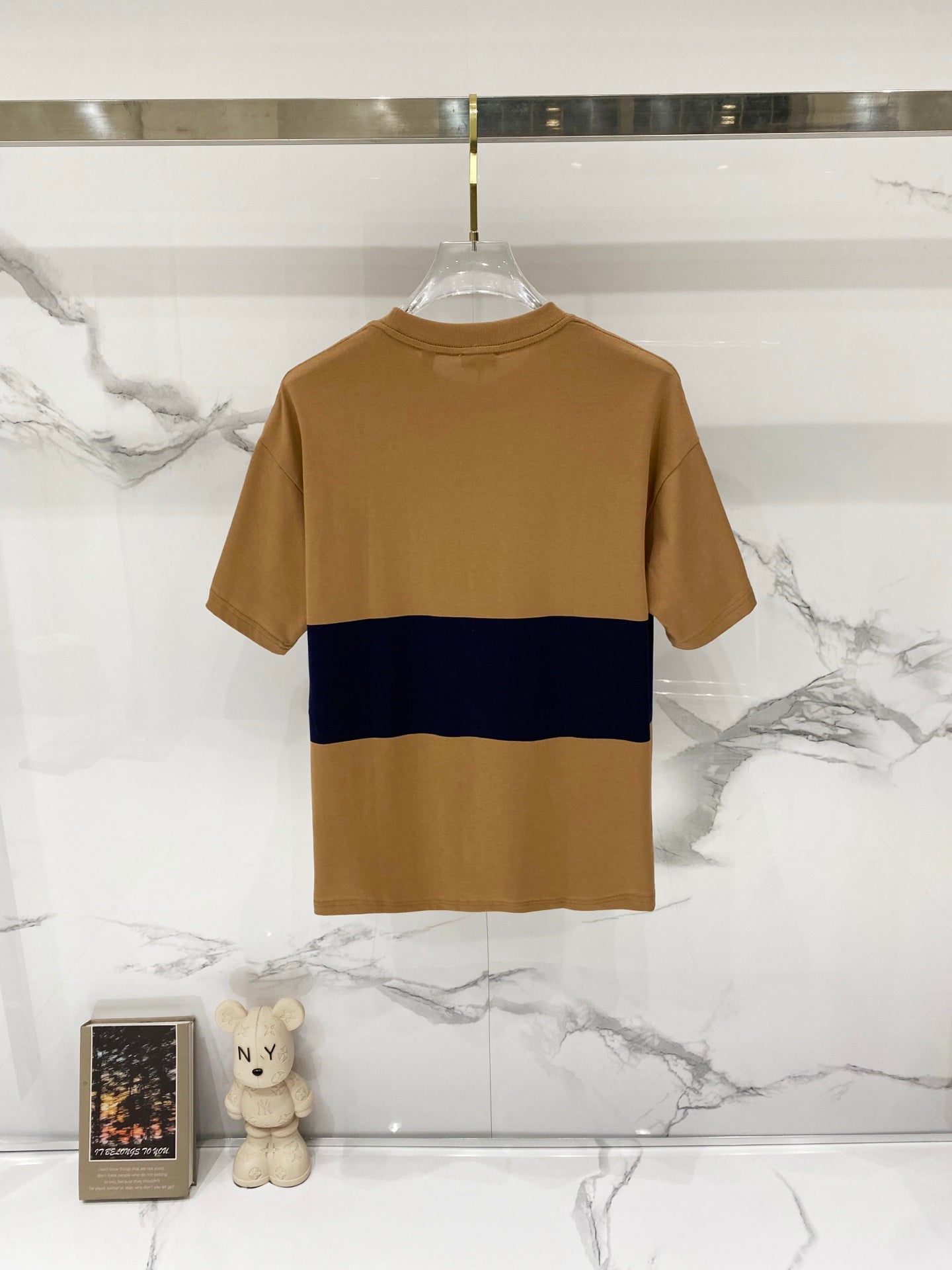 Tan crewneck short-sleeve T-shirt with navy stripe across the chest