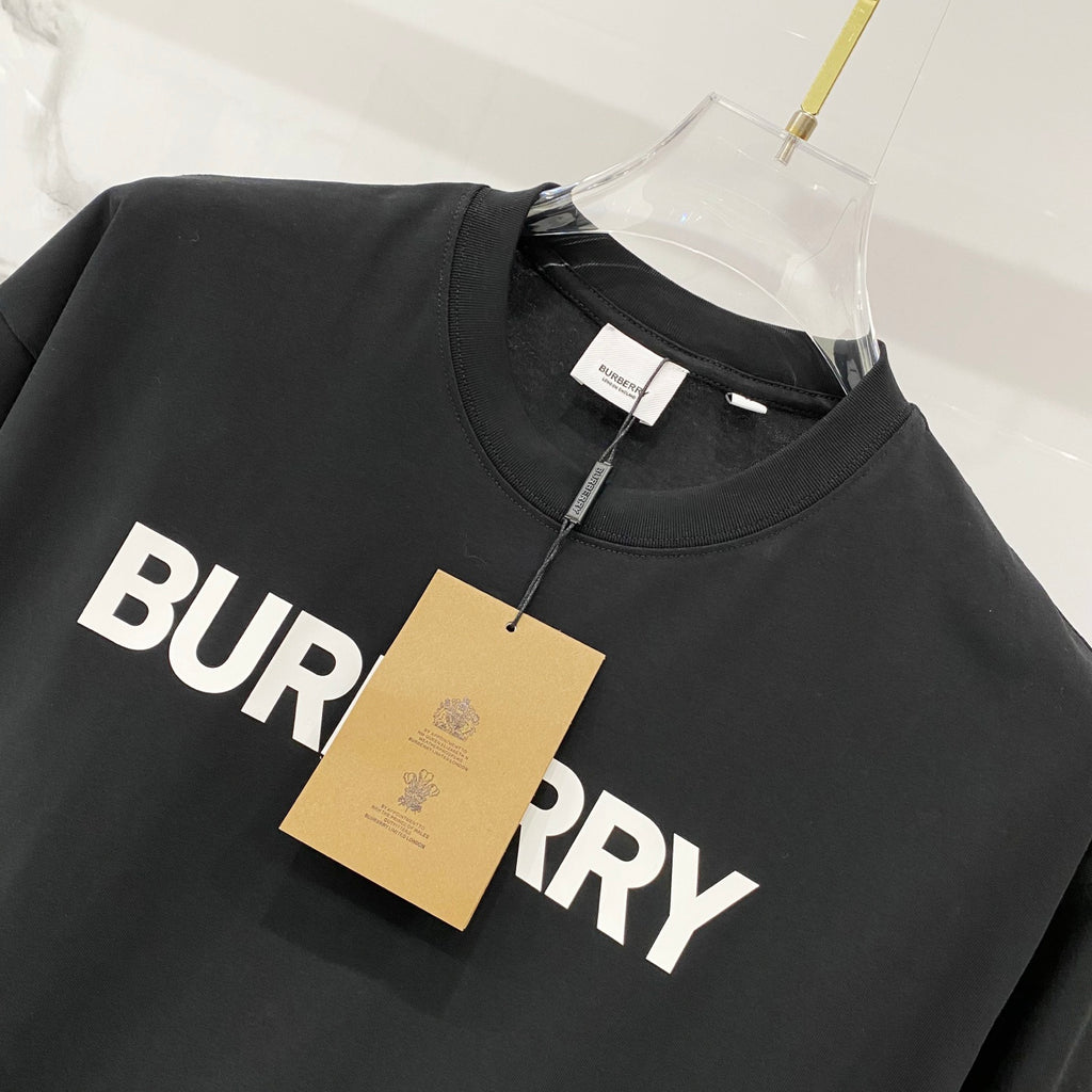 Black short-sleeve T-shirt with large white BURBERRY lettering and gold hang tag