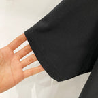 Black T-shirt fabric close-up of sleeve hem edge