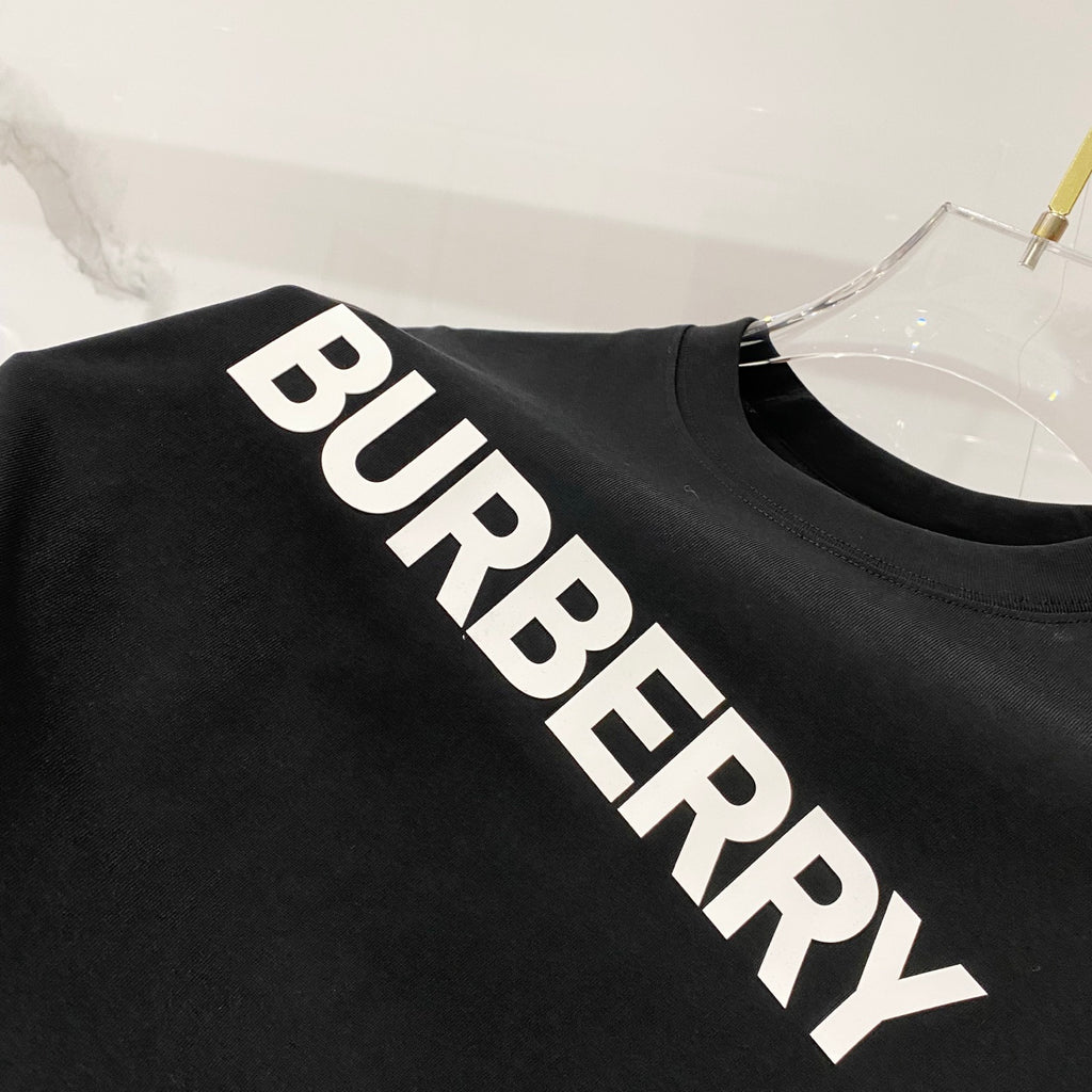 Black T-shirt close-up showing white diagonal BURBERRY lettering