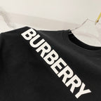 Black T-shirt close-up showing white diagonal BURBERRY lettering