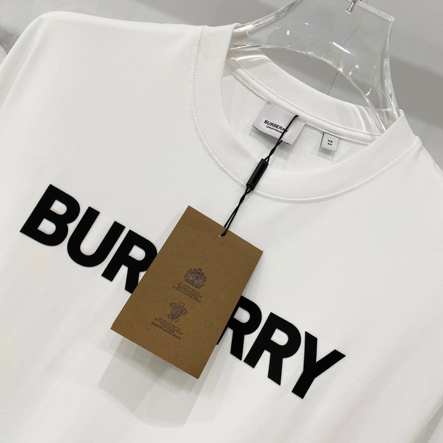 White Burberry short-sleeve T-shirt with black BURBERRY logo and price tag