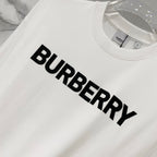 White Burberry short-sleeve T-shirt with large black BURBERRY logo, close-up