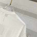 White Burberry sleeveless? No—short-sleeve T-shirt with smooth side drape, close view