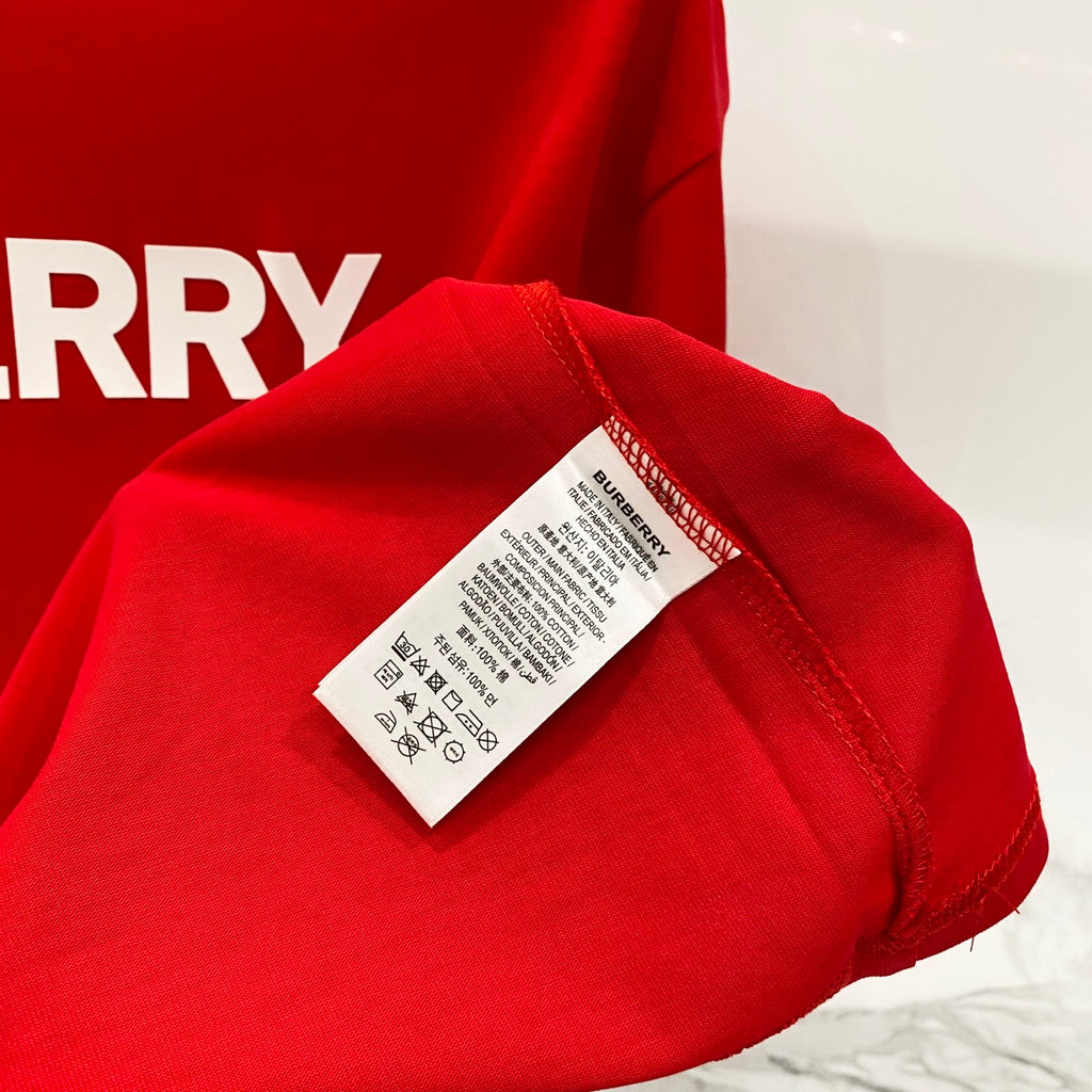 Red Burberry T-shirt care label detail on sleeve