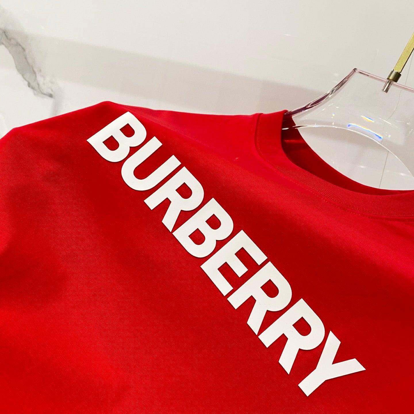 Red Burberry T-shirt close-up of BURBERRY logo lettering