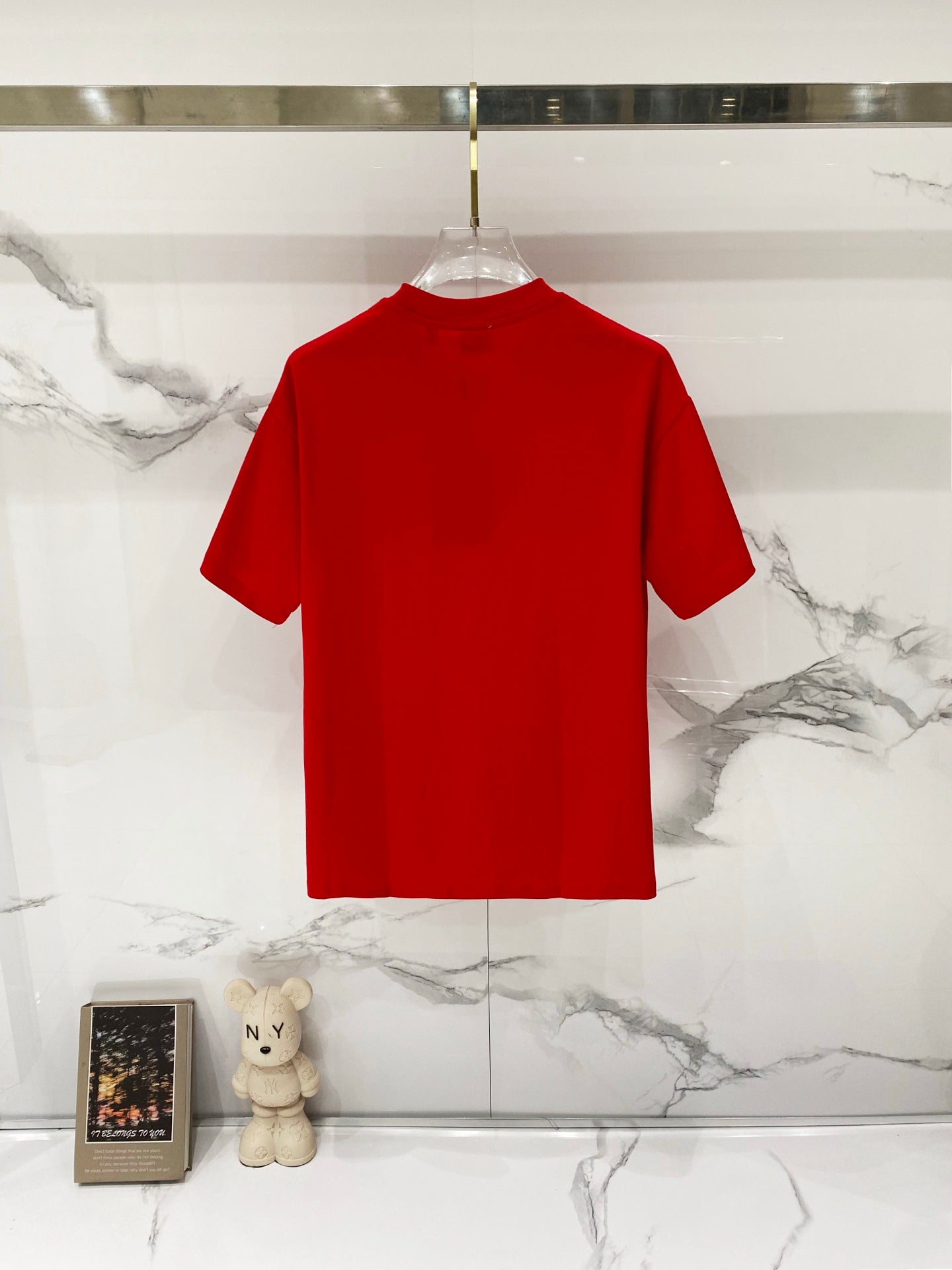 Red Burberry T-shirt back view hanging on clear plastic hanger