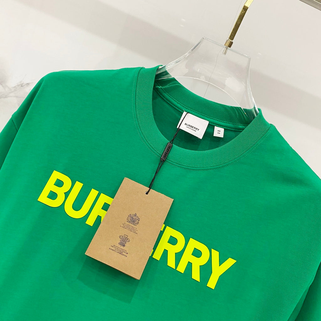 Green T-shirt with yellow 'BURBERRY' logo and hanging tag