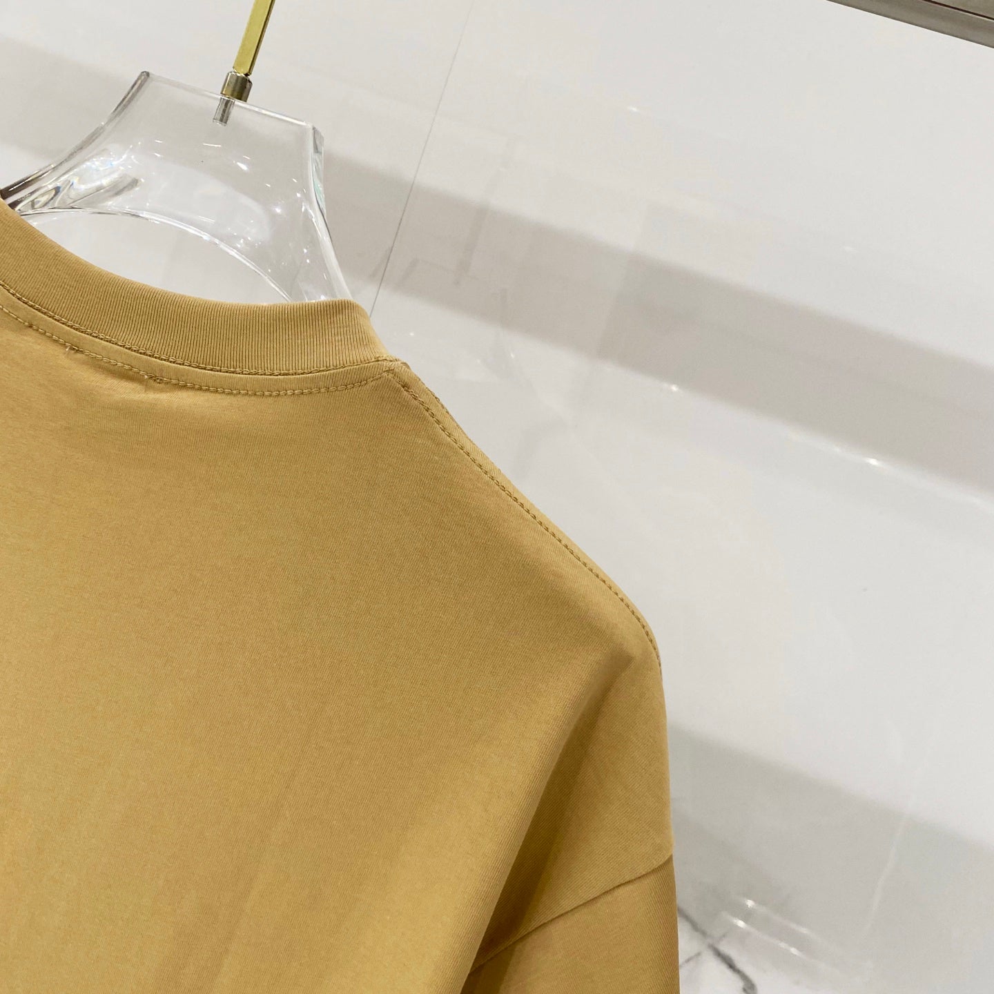 Burberry tan T-shirt shoulder and sleeve seam close-up