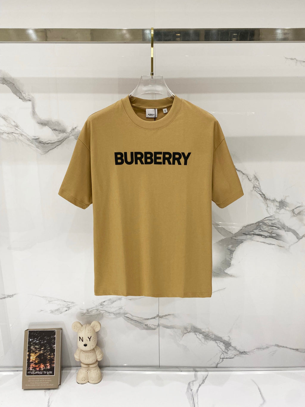 Burberry logo T-shirt in tan with bold black "BURBERRY" print on the chest