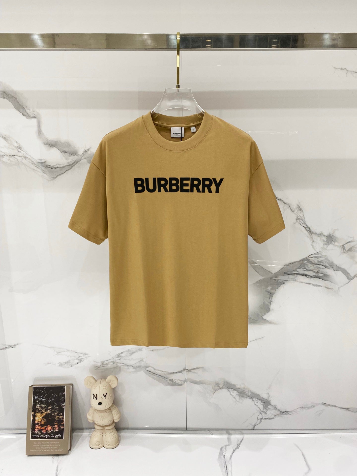 Burberry logo T-shirt in tan with bold black "BURBERRY" print on the chest