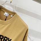 Burberry tan T-shirt close-up of collar and partial "BURRY" logo print